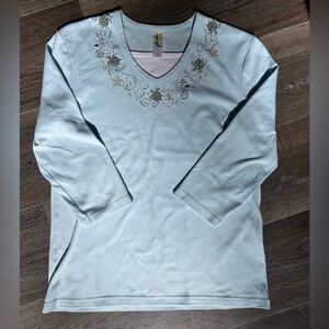 Light blue 3/4 sleeve top with sea turtle rhinestone details Size Medium.